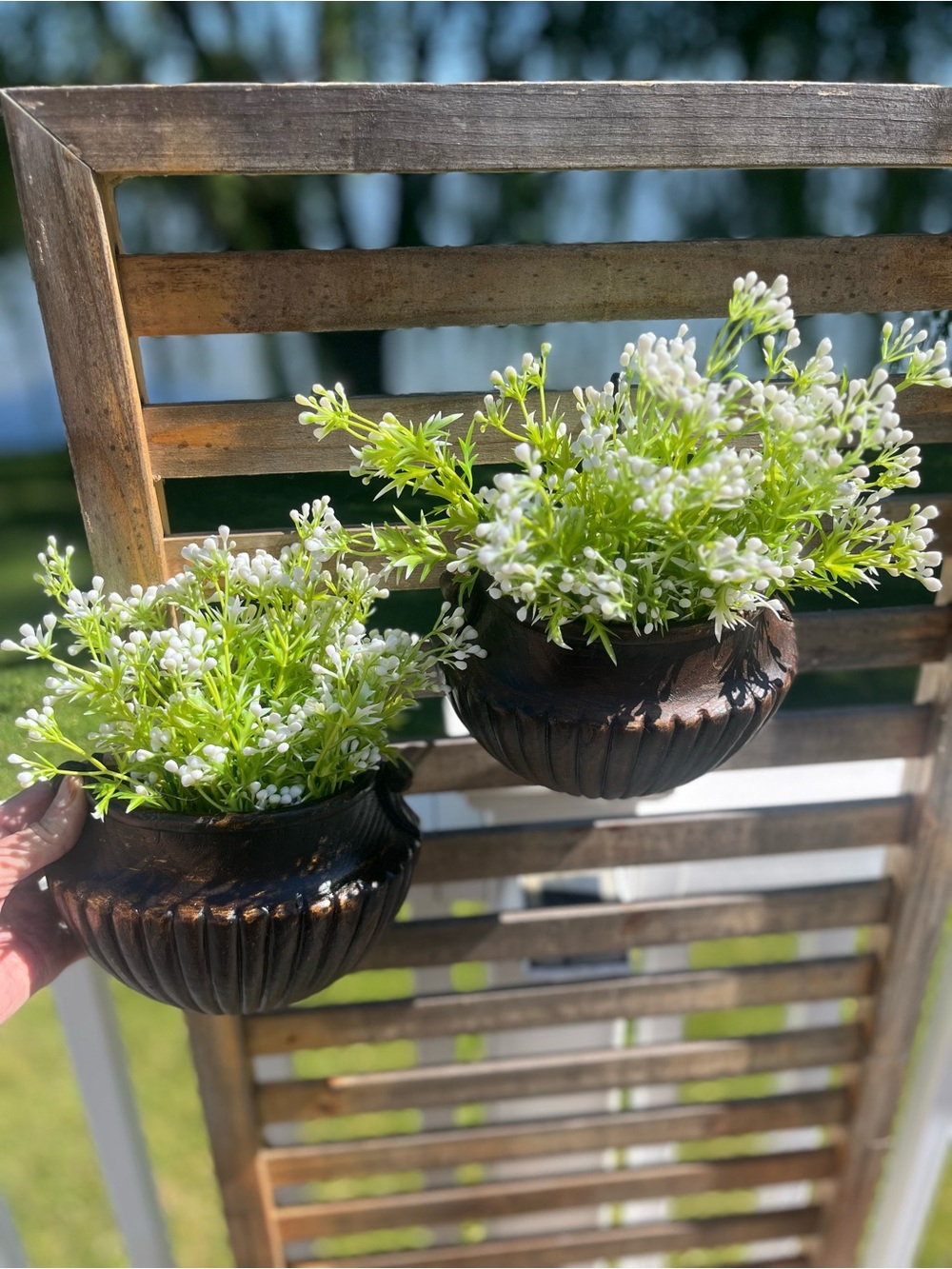 Rustic Brown Wall Planter Pair with White Floral Accents in faux wood urns